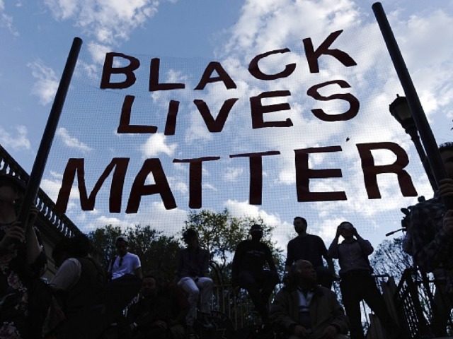 Black Lives Matter angling their banner towards the sky for aliens to see.