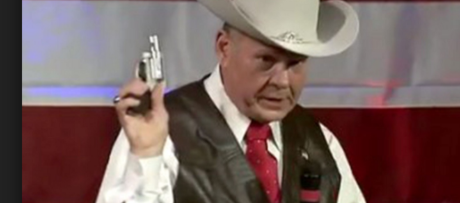 Roy Moore in cute Halloween outfit that came with a pocketbook pistol.