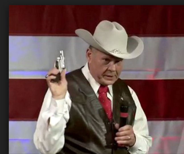 Roy Moore in cute Halloween outfit that came with a pocketbook pistol.