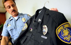 Officer showing uniform stains during press conference